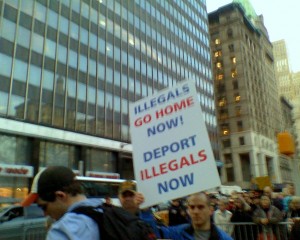 A Tea Party activist holds aloft an anti-illegal immigration sign at a rally inside of City Hall Park. 